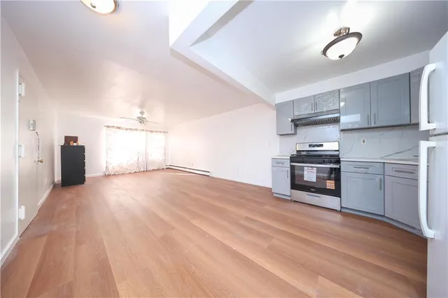 a view of a kitchen with a stove cabinets and wooden floor