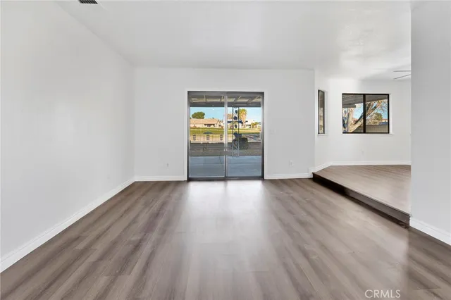 a open kitchen with stainless steel appliances granite countertop a stove and a wooden floors