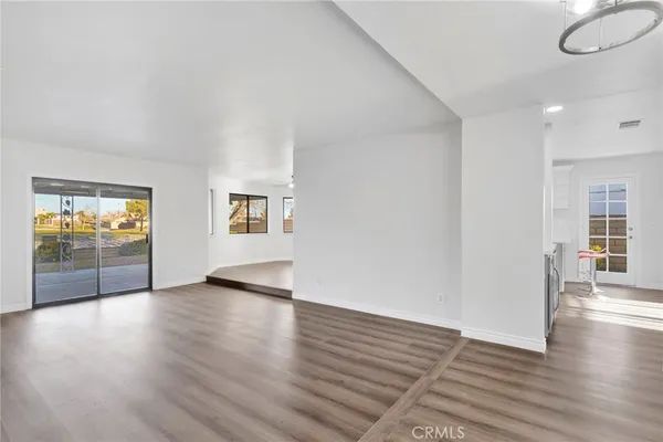 a open kitchen with stainless steel appliances granite countertop a stove and a wooden floors