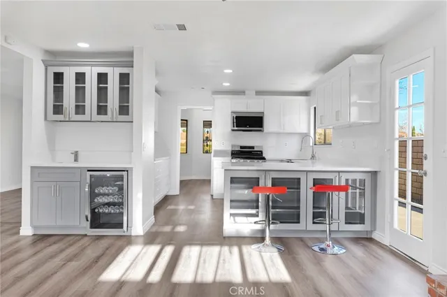 a kitchen with stainless steel appliances a stove a microwave and cabinets