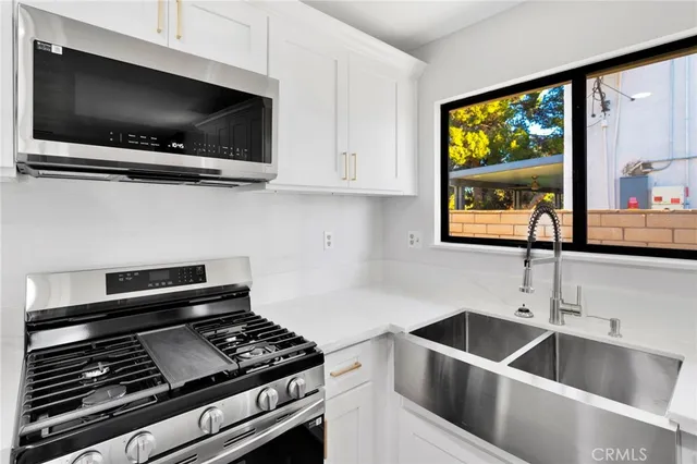 an empty room with a window and ceiling fan