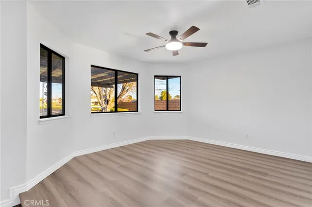 a view of an empty room and wooden floor