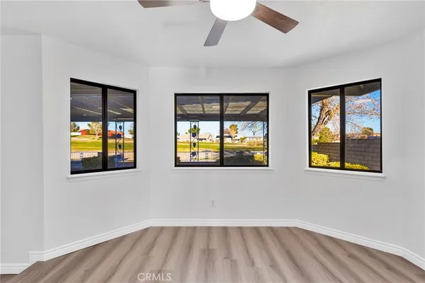 a view of an empty room and wooden floor