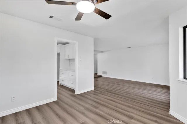 a bathroom with a granite countertop sink a toilet and a mirror