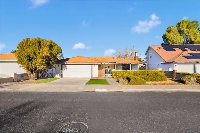 a view of a house with a yard and a garage