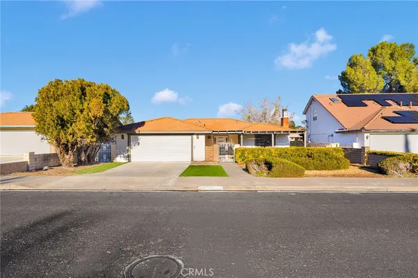 a view of a house with a yard and a garage
