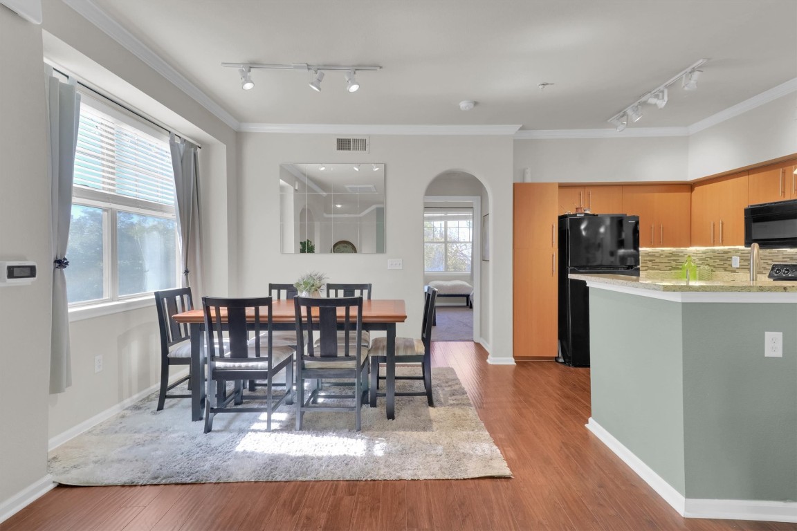 11203 Ranch Road 2222, Unit 2305 Austin, TX 78730 - Photo 10 of 36 a view of a dining room with furniture window and wooden floor
