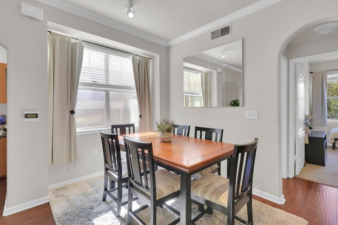 11203 Ranch Road 2222, Unit 2305 Austin, TX 78730 - Photo 11 of 36 a view of a dining room with furniture and wooden floor