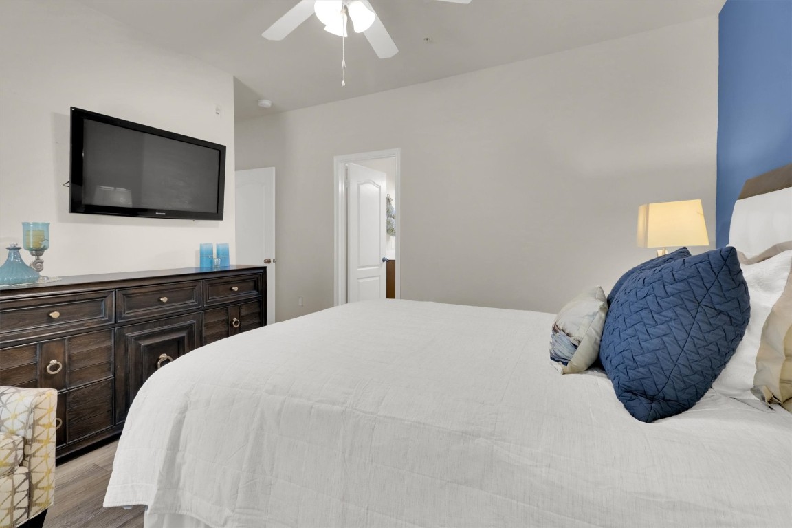 11203 Ranch Road 2222, Unit 2305 Austin, TX 78730 - Photo 16 of 36 a bedroom with a bed and a flat screen tv