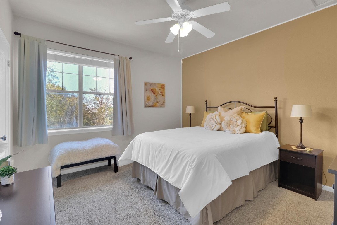 11203 Ranch Road 2222, Unit 2305 Austin, TX 78730 - Photo 19 of 36 a bedroom with a bed and window
