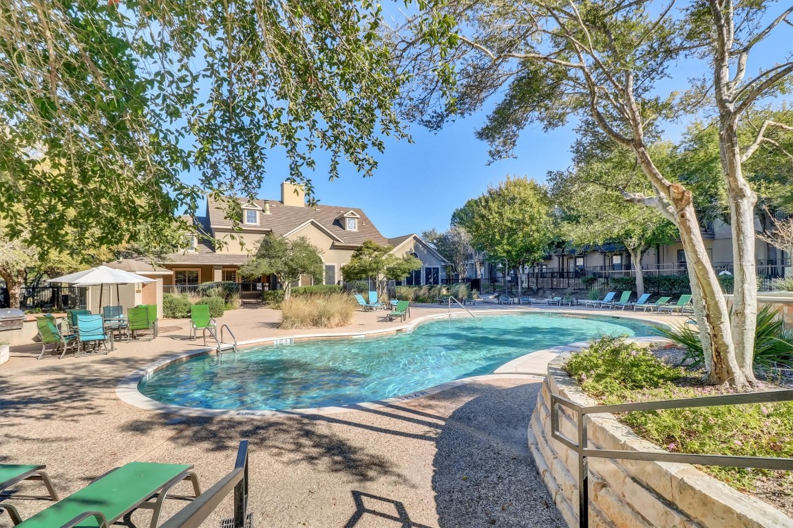 11203 Ranch Road 2222, Unit 2305 Austin, TX 78730 - Photo 27 of 36 a front view of a house with a yard