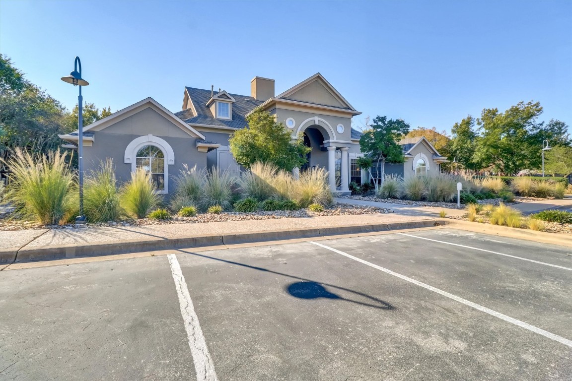 11203 Ranch Road 2222, Unit 2305 Austin, TX 78730 - Photo 29 of 36 a front view of a house with a yard and potted plants