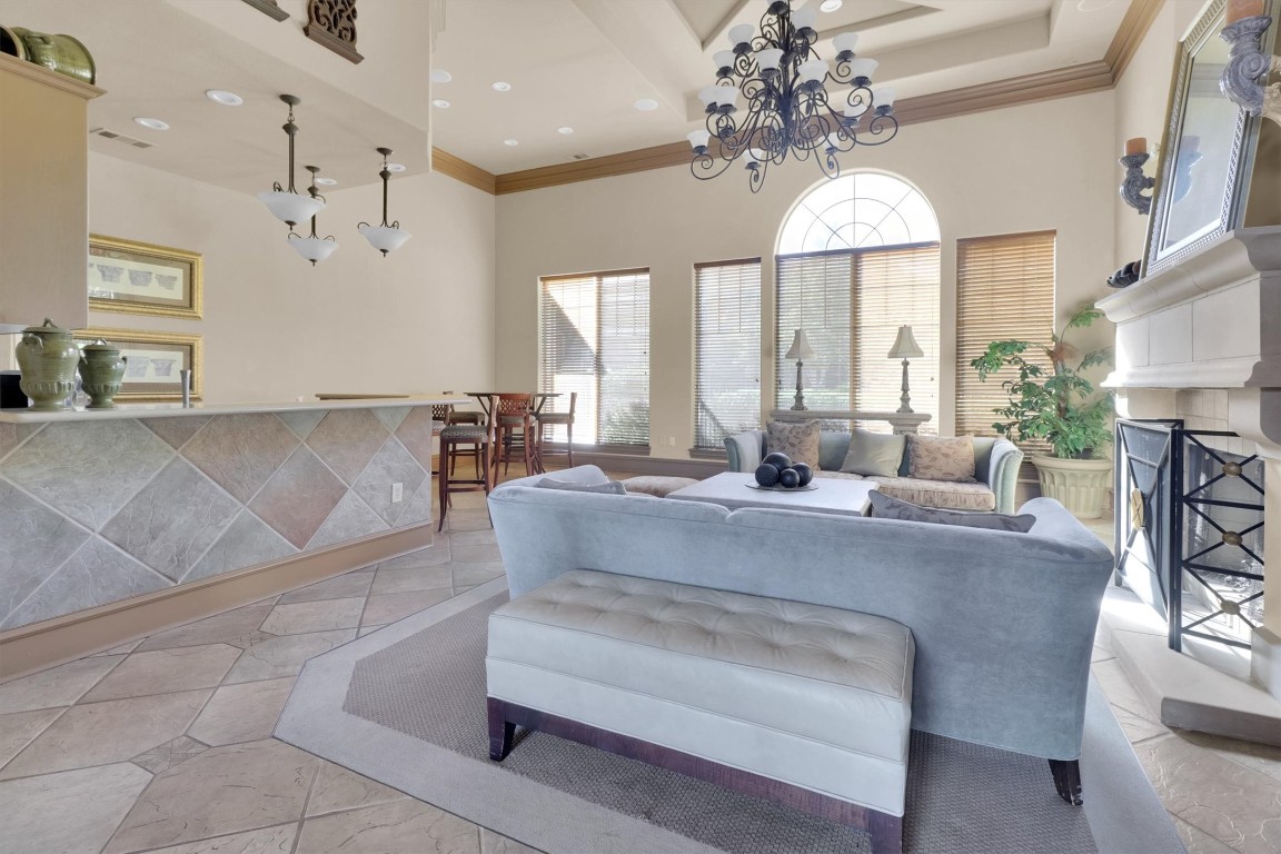 11203 Ranch Road 2222, Unit 2305 Austin, TX 78730 - Photo 30 of 36 a living room with furniture and a chandelier