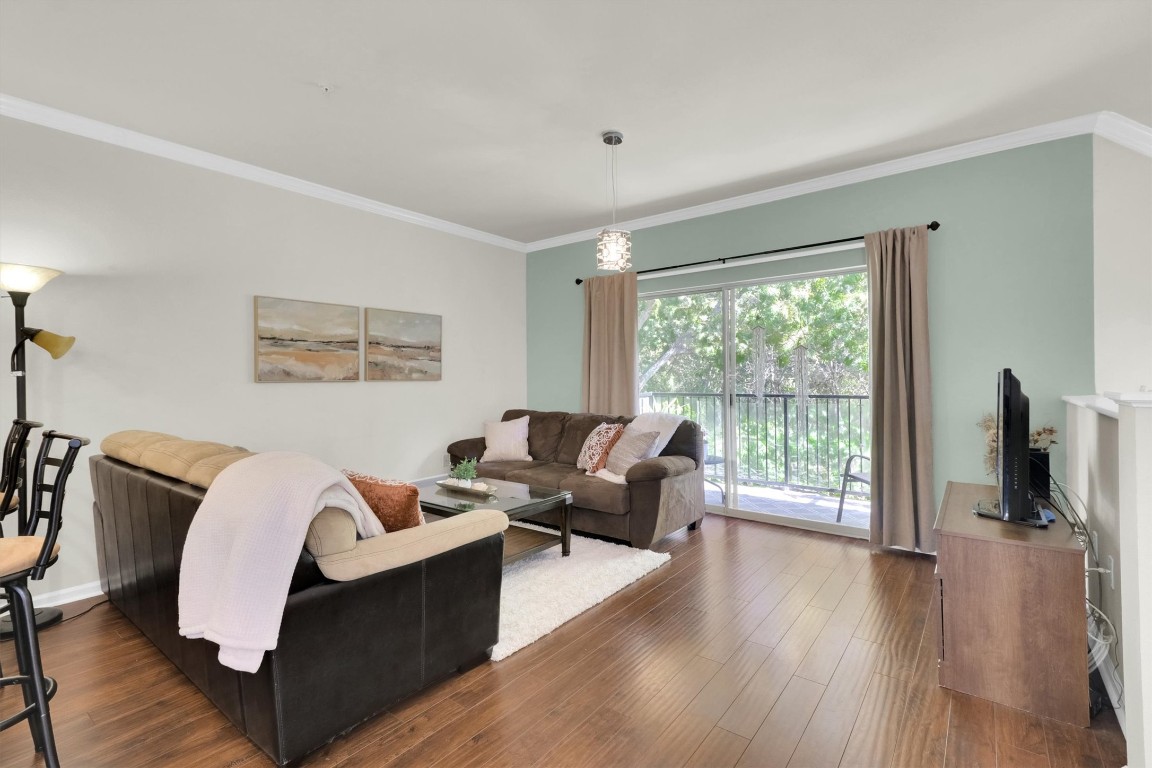 11203 Ranch Road 2222, Unit 2305 Austin, TX 78730 - Photo 4 of 36 a living room with furniture large window and wooden floor