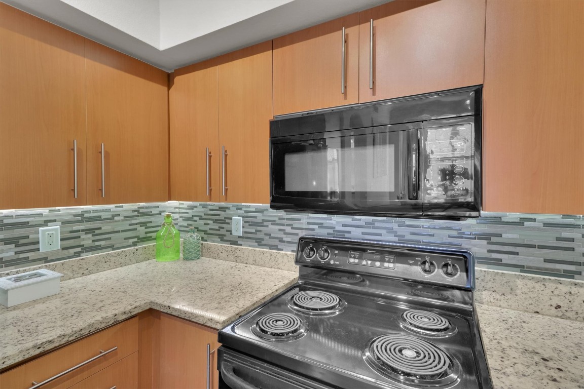 11203 Ranch Road 2222, Unit 2305 Austin, TX 78730 - Photo 8 of 36 a kitchen with a stove and a microwave