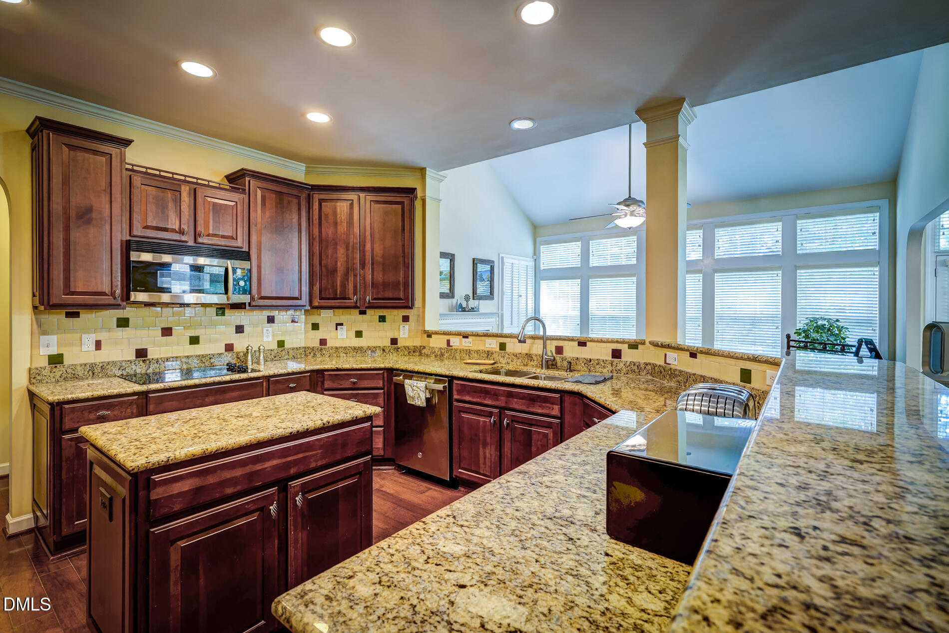 12212 Ashton Woods Lane Raleigh, NC 27614 - Photo 12 of 50 a kitchen with kitchen island granite countertop a sink stove and cabinets