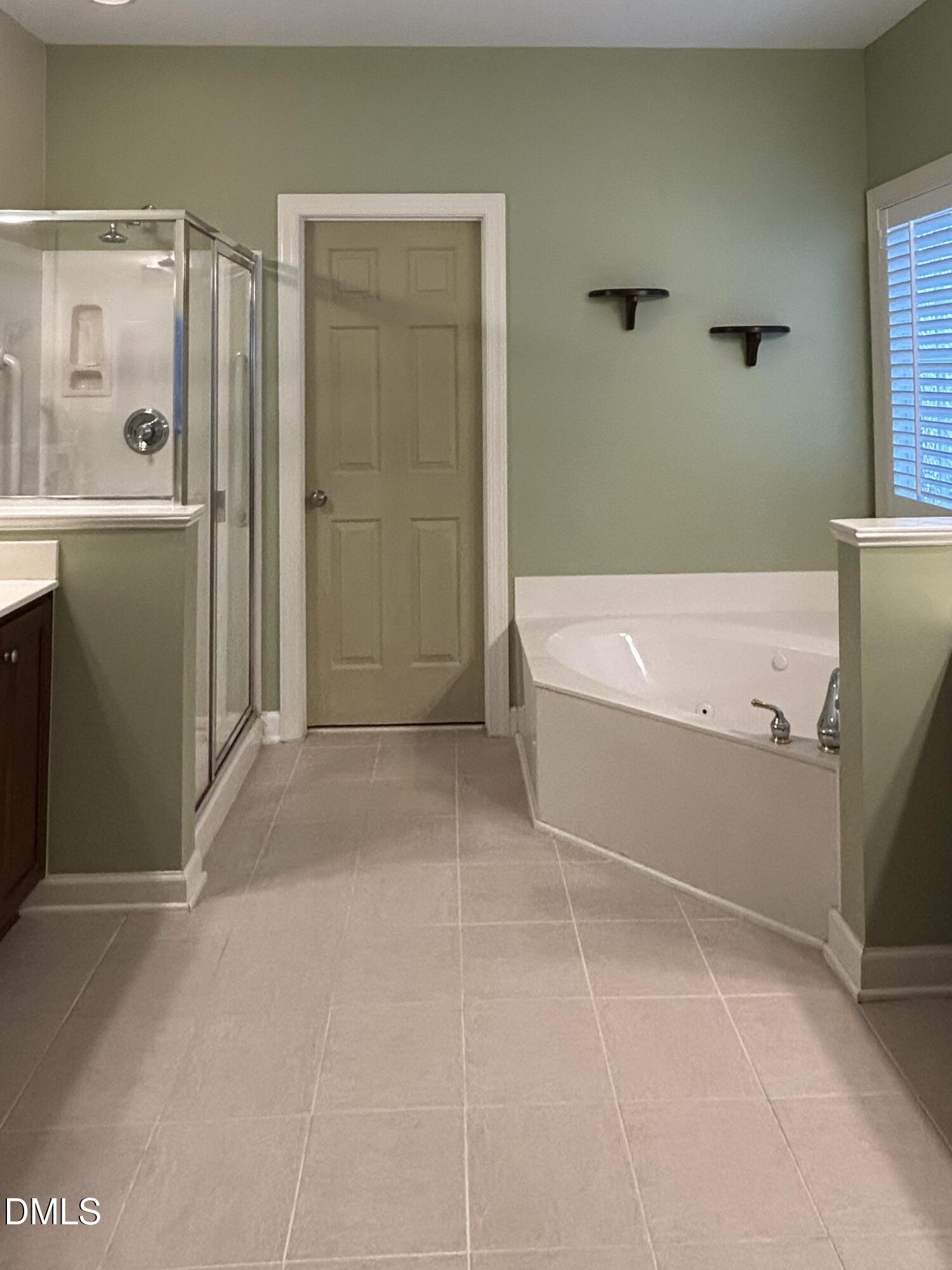 12212 Ashton Woods Lane Raleigh, NC 27614 - Photo 23 of 50 a bathroom with a bathtub and a shower
