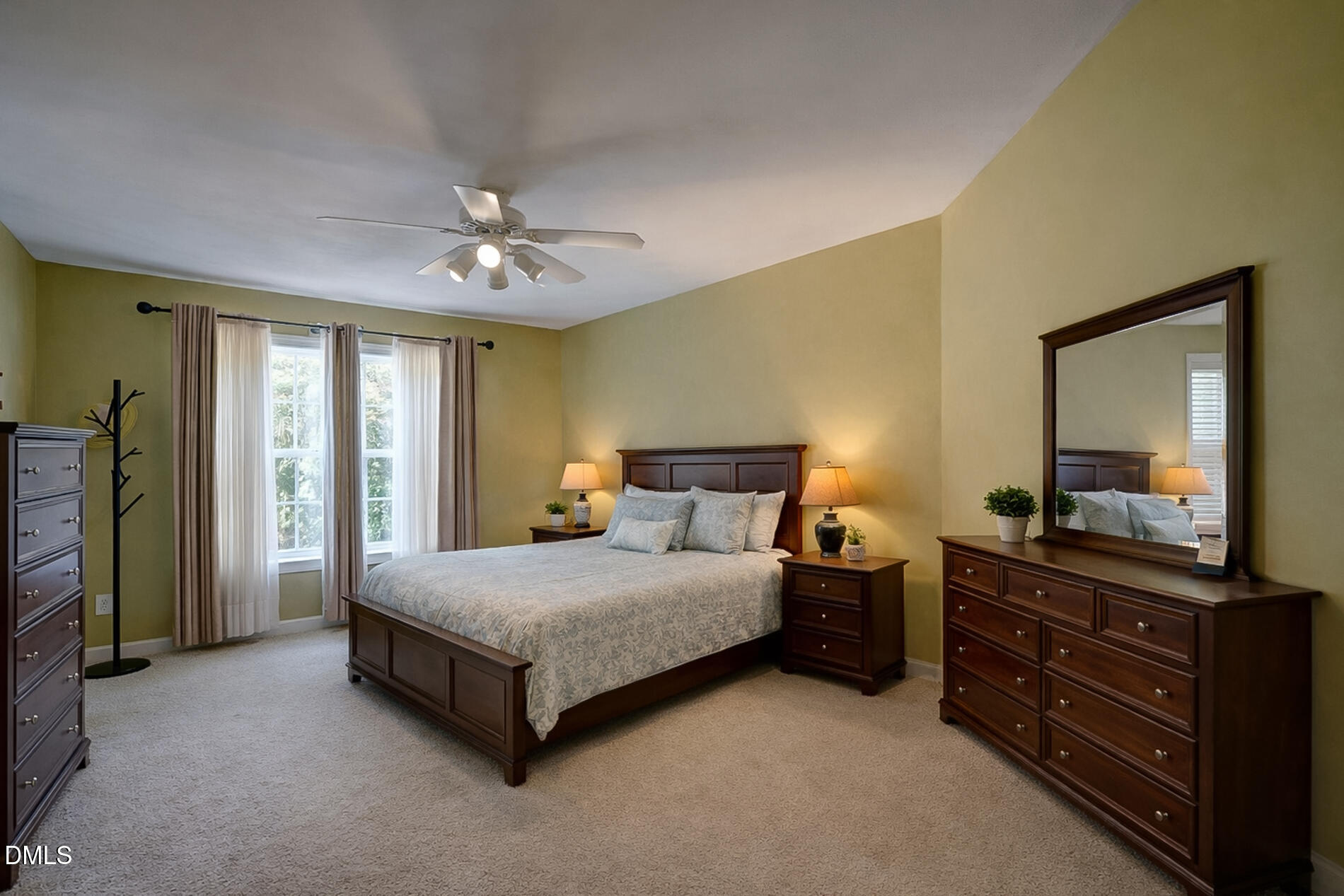 12212 Ashton Woods Lane Raleigh, NC 27614 - Photo 28 of 50 a bedroom with a bed and a dresser with mirror
