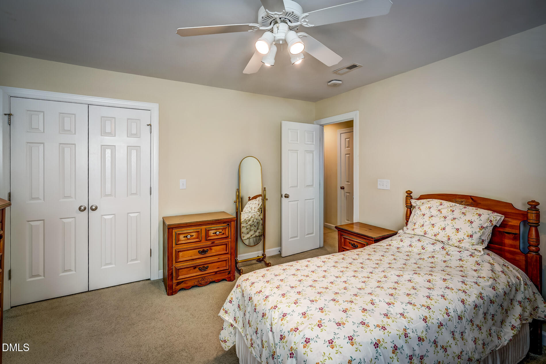 12212 Ashton Woods Lane Raleigh, NC 27614 - Photo 30 of 50 a bedroom with a bed and a chandelier