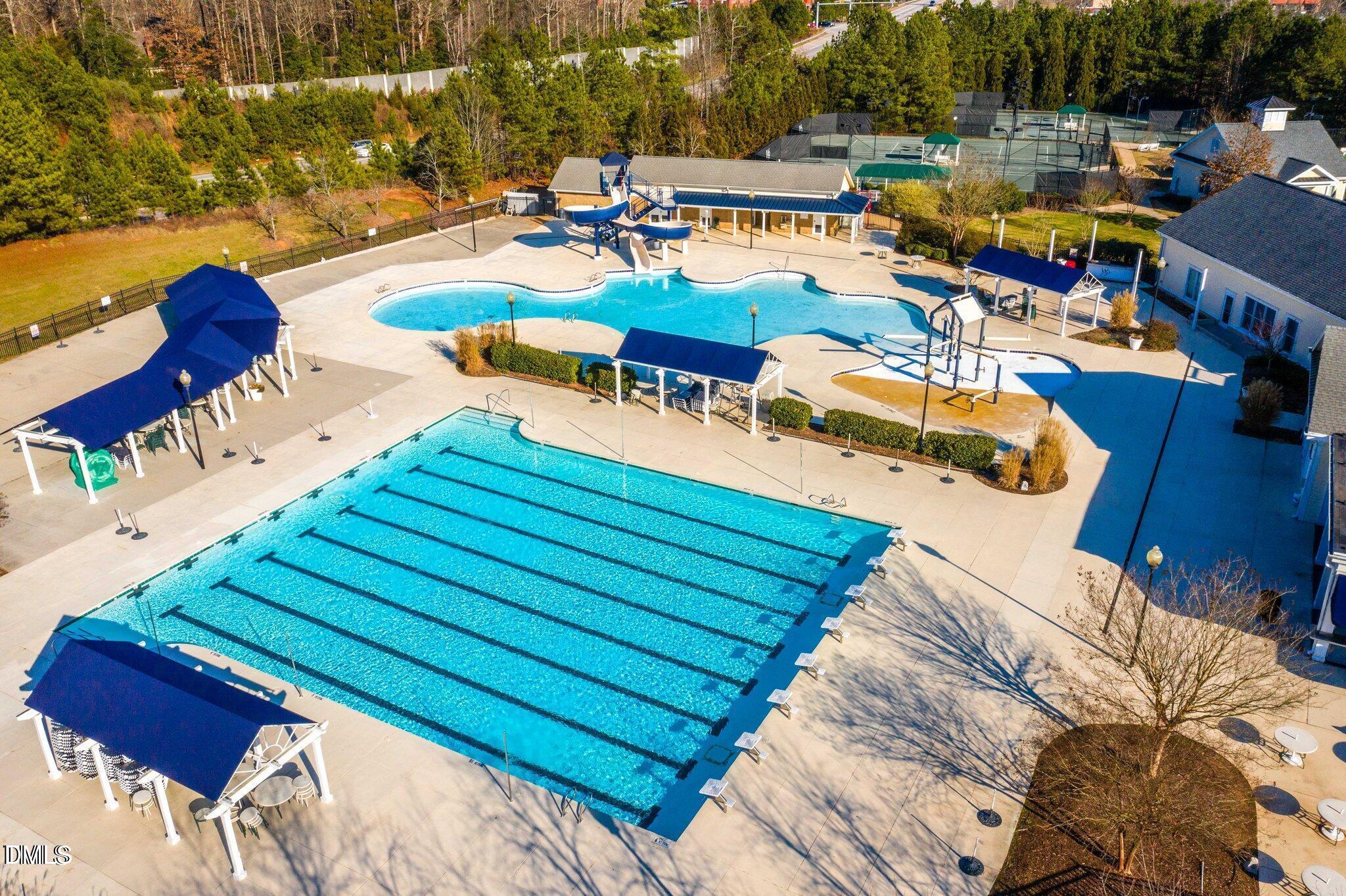 12212 Ashton Woods Lane Raleigh, NC 27614 - Photo 47 of 50 a view of a swimming pool with lounge chairs on wooden deck