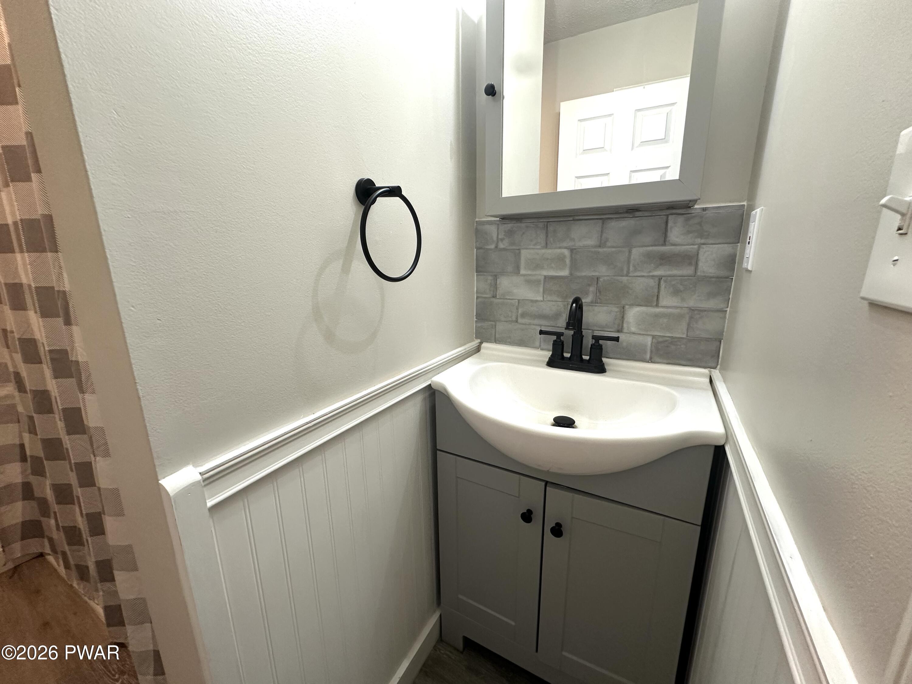 2116 Spring Drive Bushkill, PA 18324 - Photo 12 of 19 a bathroom with a sink a mirror a vanity and window