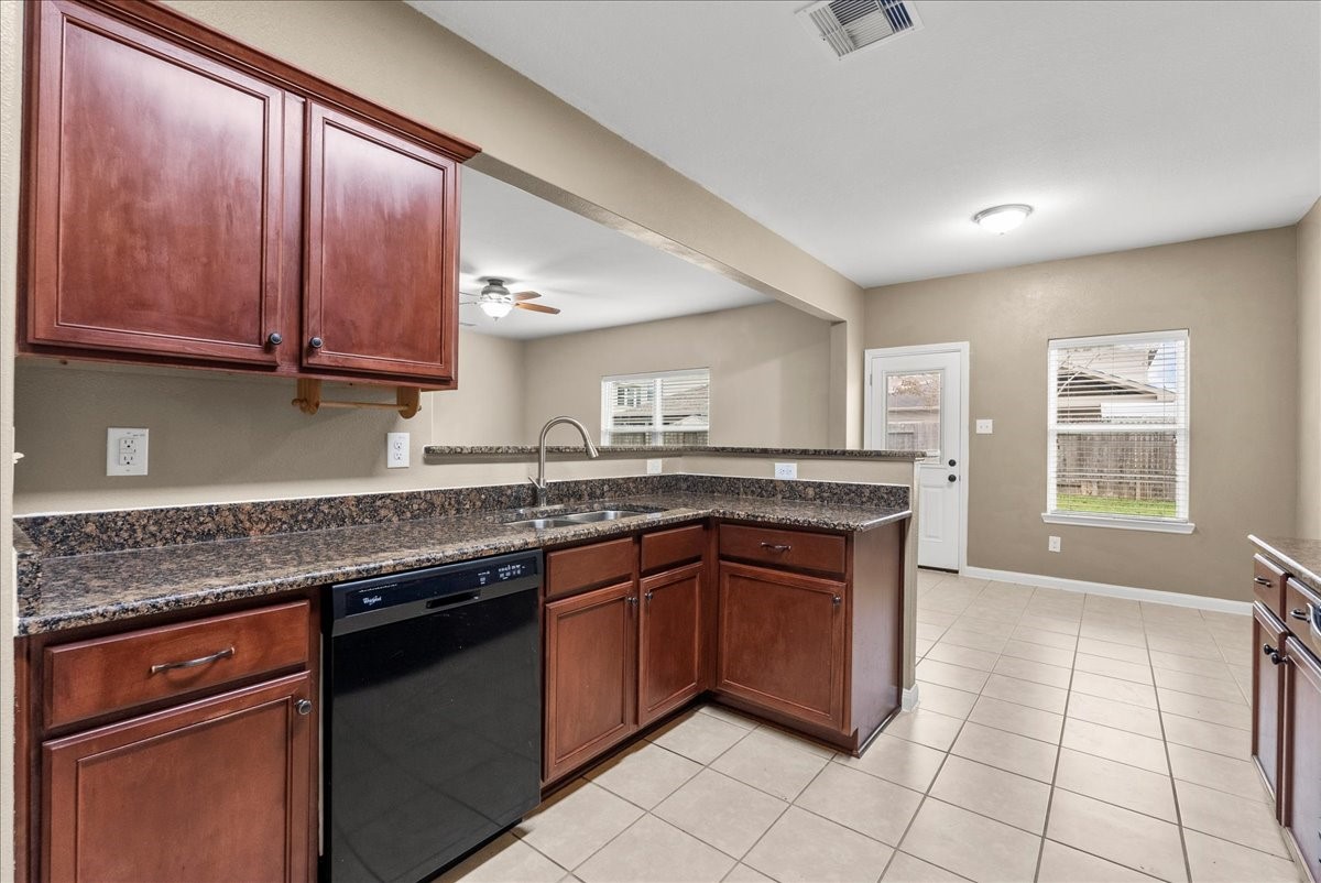 322 Shoshone Ridge Drive La Marque, TX 77568 - Photo 14 of 34 a kitchen with granite countertop a sink stove and cabinets