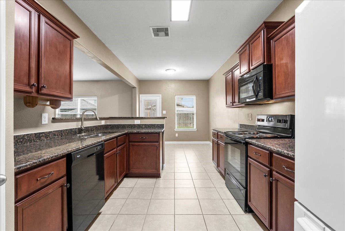 322 Shoshone Ridge Drive La Marque, TX 77568 - Photo 15 of 34 a kitchen with stainless steel appliances granite countertop a stove sink and cabinets