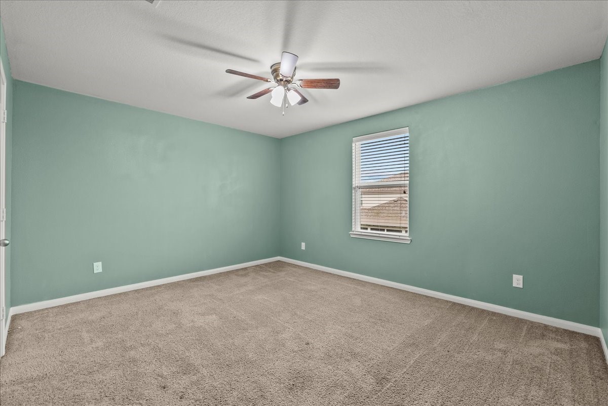 322 Shoshone Ridge Drive La Marque, TX 77568 - Photo 24 of 34 an empty room with windows and fan