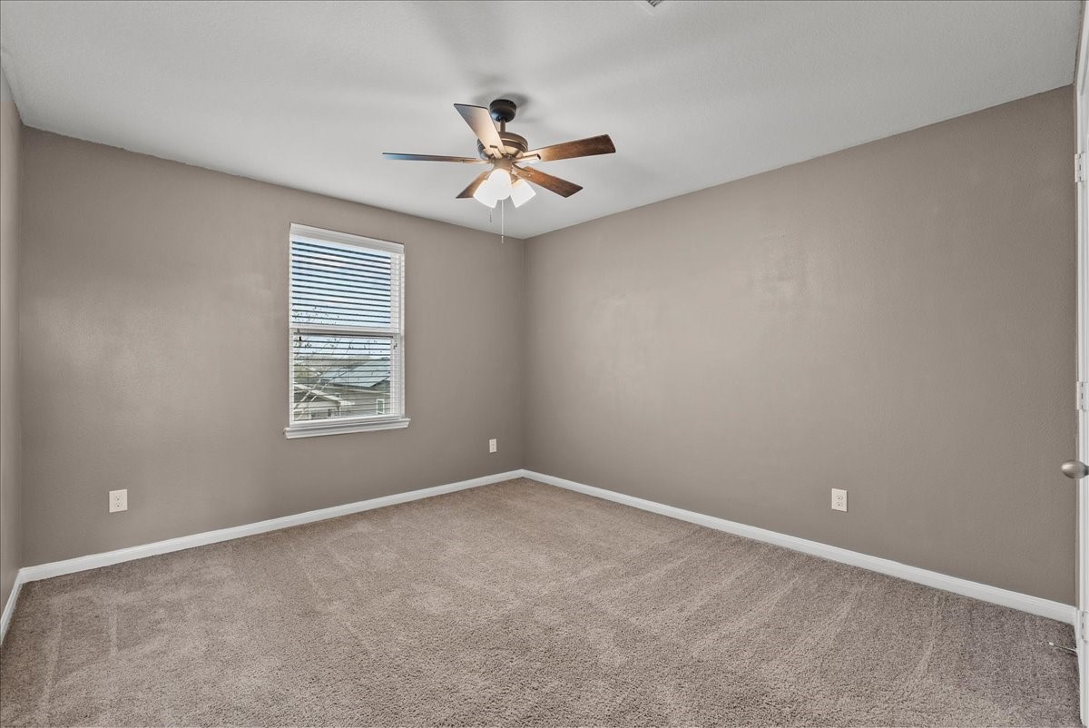 322 Shoshone Ridge Drive La Marque, TX 77568 - Photo 25 of 34 an empty room with windows and fan