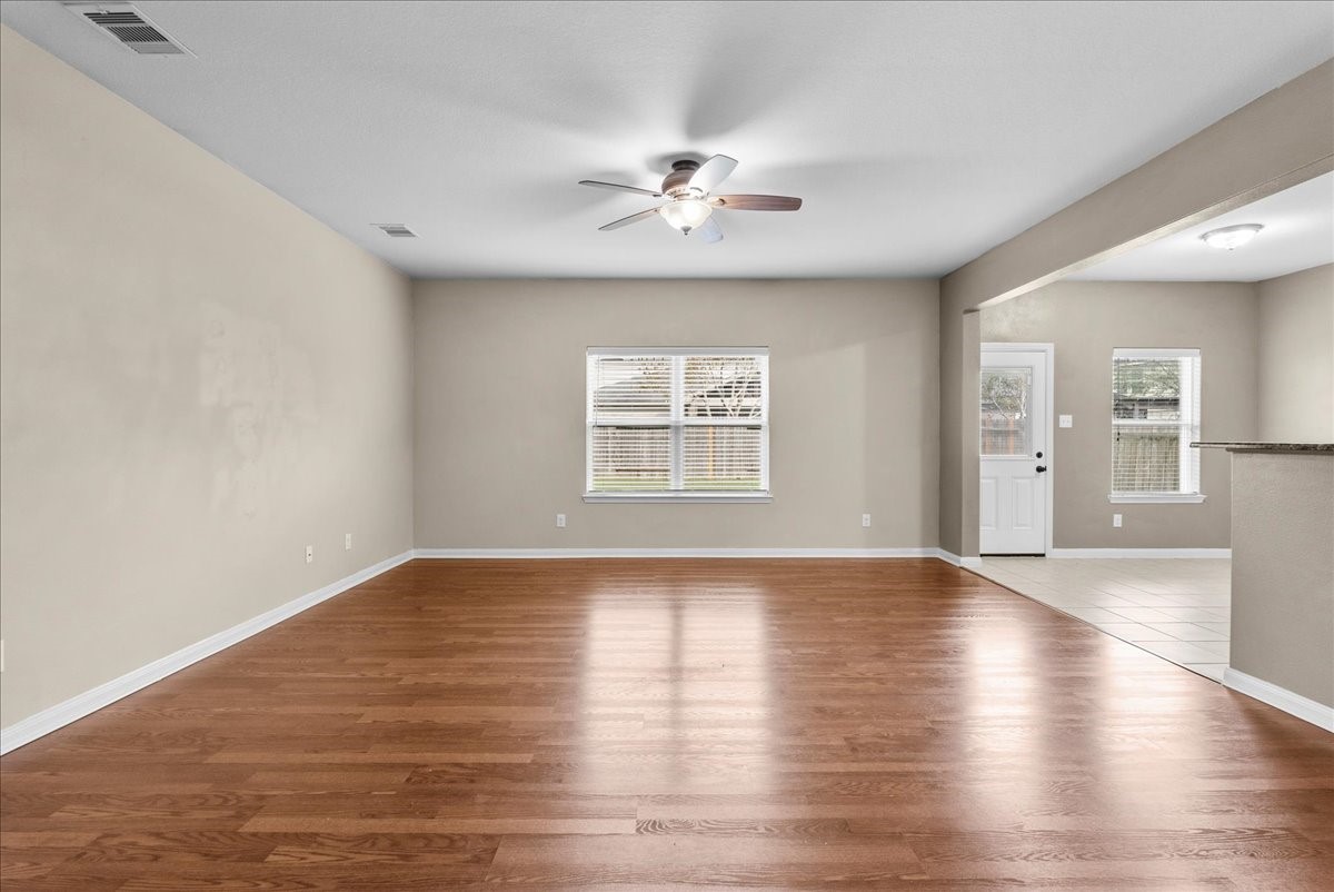322 Shoshone Ridge Drive La Marque, TX 77568 - Photo 3 of 34 a view of an empty room with wooden floor and a window