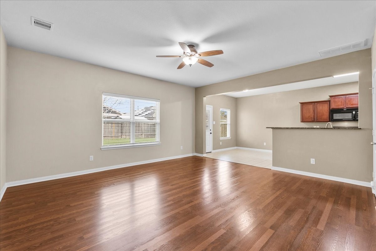 322 Shoshone Ridge Drive La Marque, TX 77568 - Photo 5 of 34 a view of an empty room with window and wooden floor