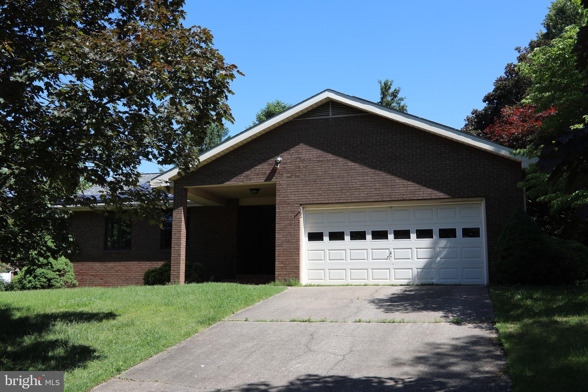 a front view of a house with a garden and yard