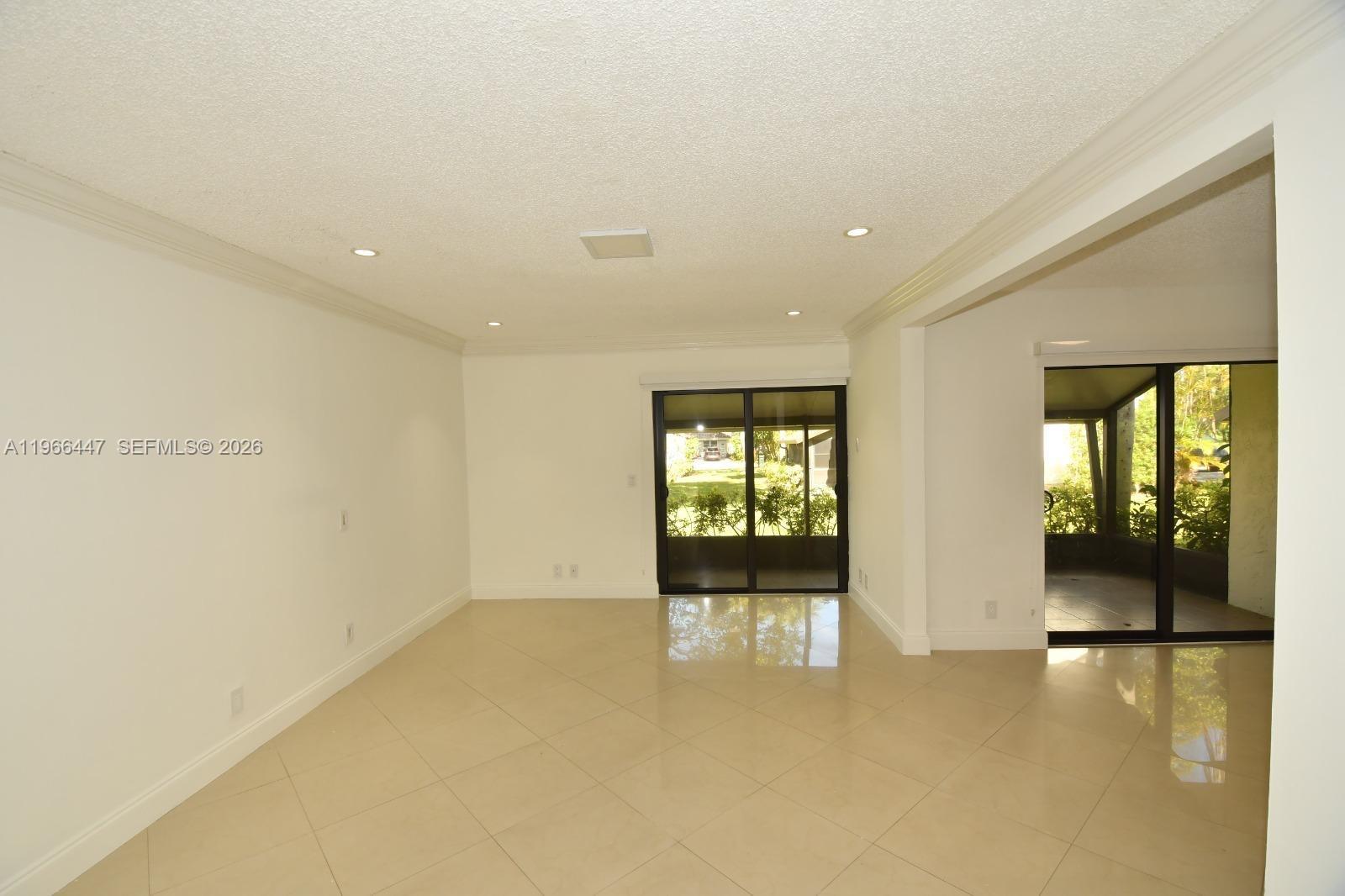 7200 Northwest 2nd Avenue, Unit 410 Boca Raton, FL 33487 - Photo 8 of 20 a view of an empty room with glass door