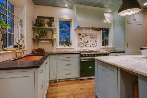 a kitchen with stainless steel appliances granite countertop a stove and a sink