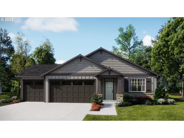 a front view of a house with a garden and yard