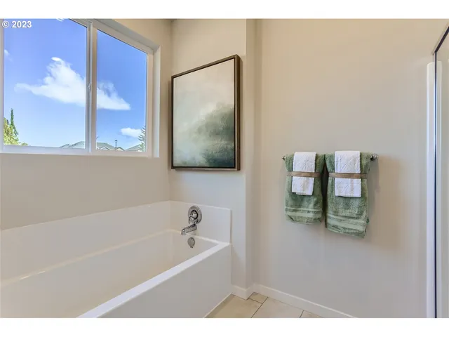a bathroom with a bathtub sink and mirror
