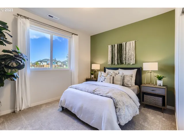 a bedroom with a bed and a potted plant