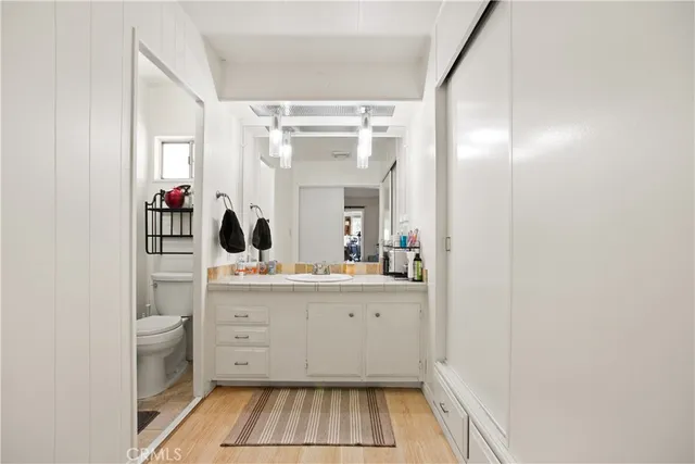 a bathroom with a sink mirror and vanity