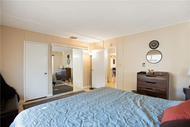 a bedroom with a bed and a dresser