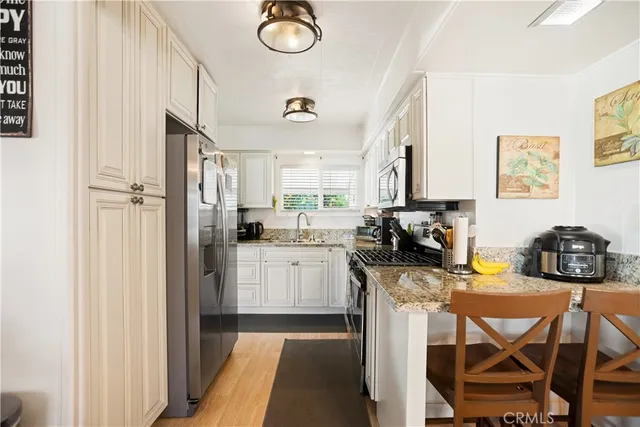 a kitchen with a refrigerator and cabinets