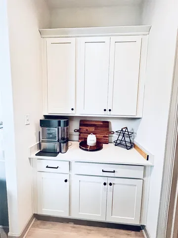 a kitchen with white cabinets and white appliances