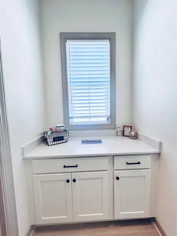 a sink with white cabinets