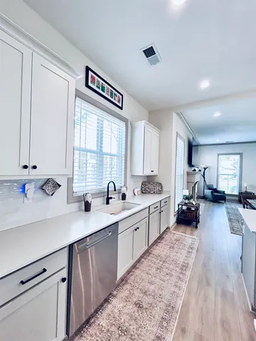 a kitchen with a sink stove and cabinets