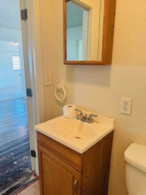217 Main Street Palacios, TX 77465 - Photo 29 of 45 a bathroom with a sink a toilet and vanity