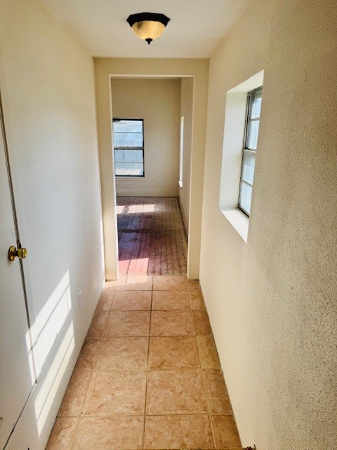 217 Main Street Palacios, TX 77465 - Photo 40 of 45 a hallway view with wooden floor and a bathroom