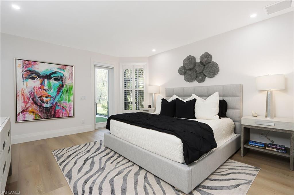 6665 Mill Run Road Naples, FL 34109 - Photo 14 of 30 a bedroom with bed and painting on the wall