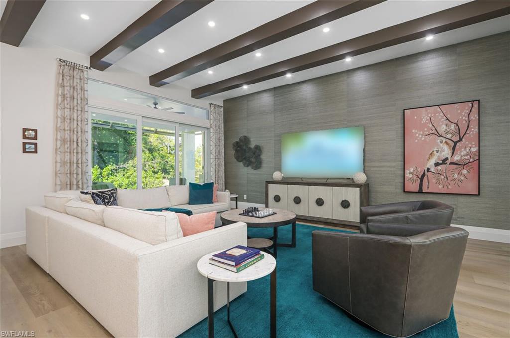 6665 Mill Run Road Naples, FL 34109 - Photo 2 of 30 a living room with furniture and a flat screen tv