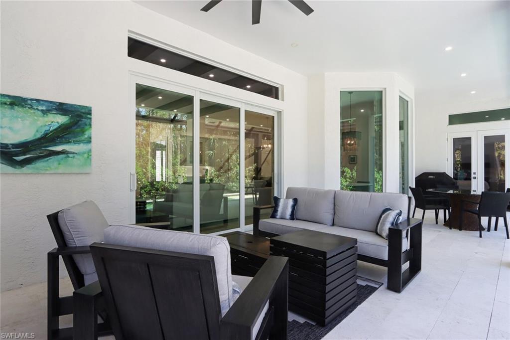 6665 Mill Run Road Naples, FL 34109 - Photo 24 of 30 a living room with furniture and a large window