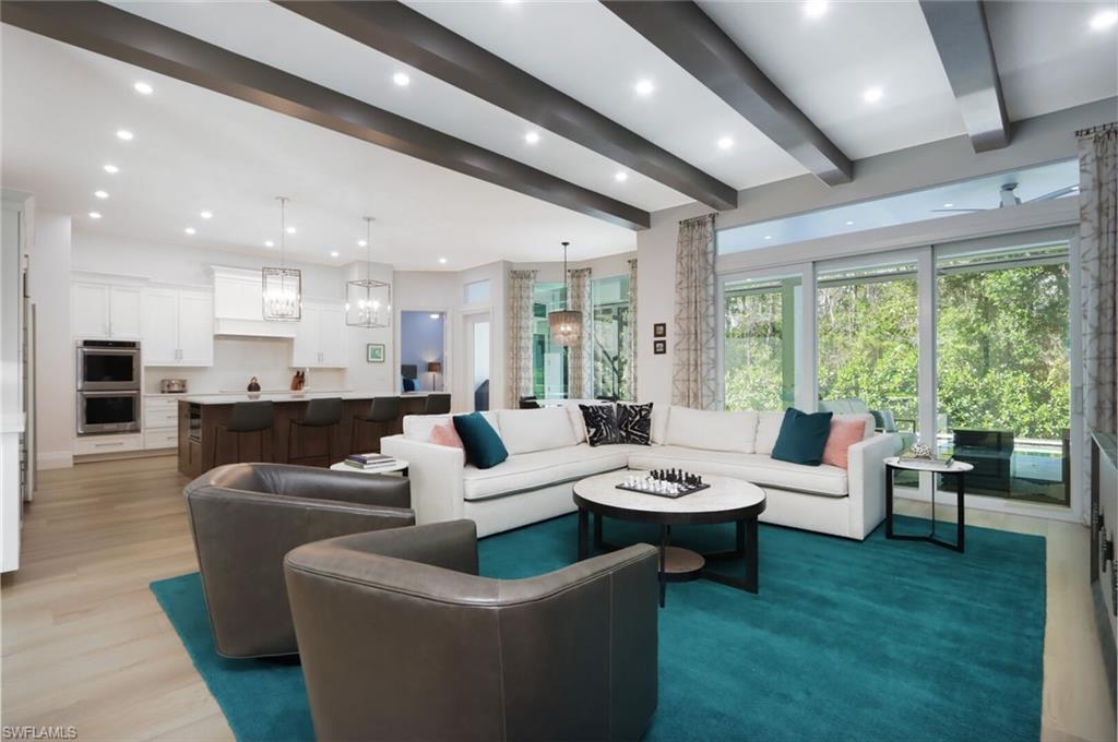 6665 Mill Run Road Naples, FL 34109 - Photo 3 of 30 a living room with furniture and a large window