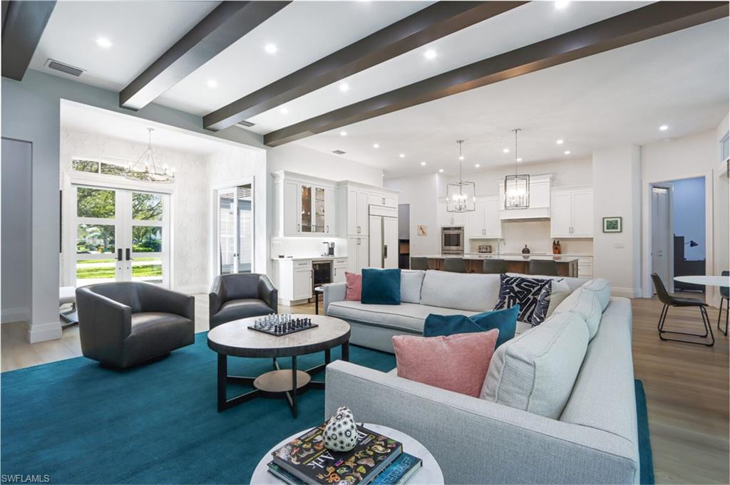 6665 Mill Run Road Naples, FL 34109 - Photo 4 of 30 a living room with furniture and a view of kitchen